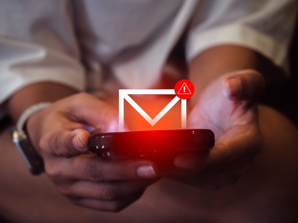 A man receives a scam SMS. SMS fraud can be tackled with QR codes and short links.