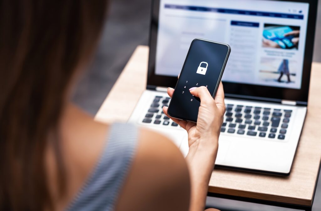 A woman keeps her mobile banking secure. PCI DSS mandates a high degree of payment security.