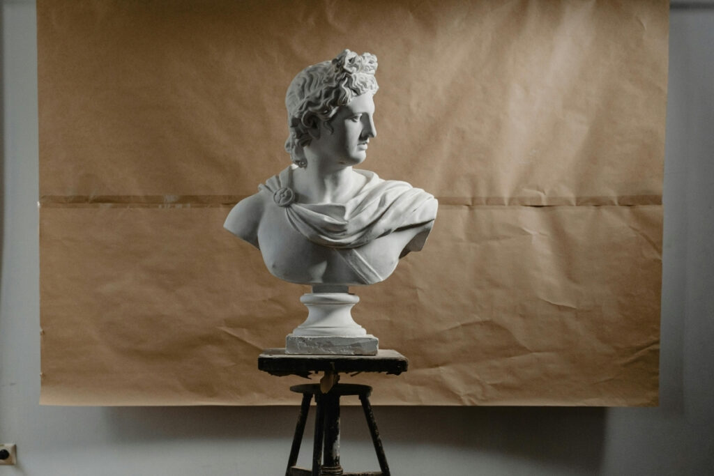 A Roman-style bust standing on a stool.