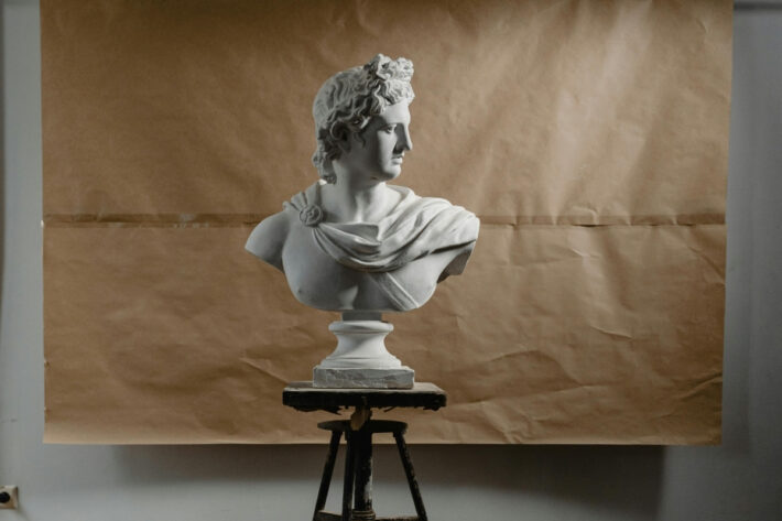 A Roman-style bust standing on a stool.